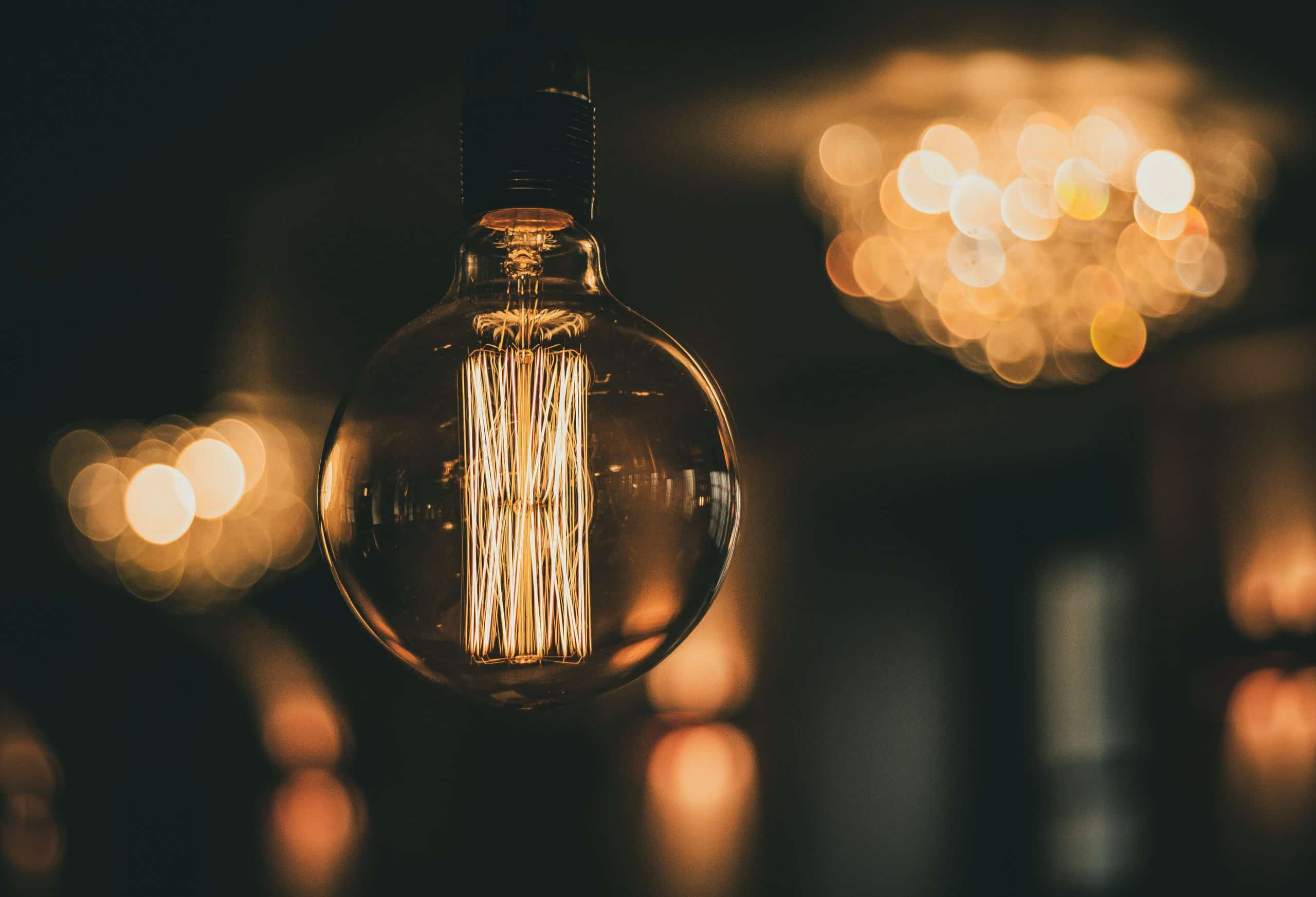 A large lightbulb with lights in the background