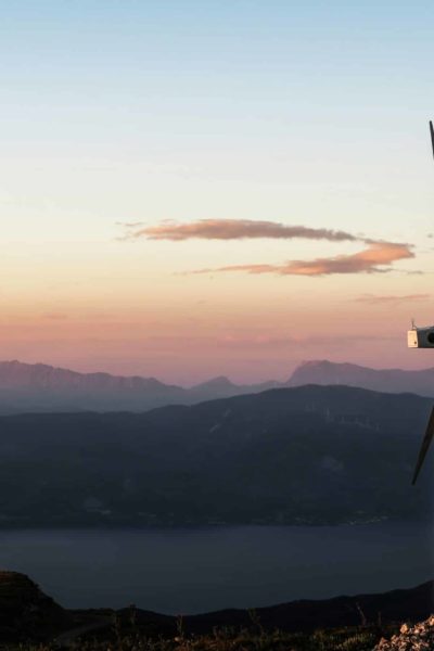 Wind turbines on top of a hilly landscape at sunrise. ISO Net Zero Standard. Sustainit