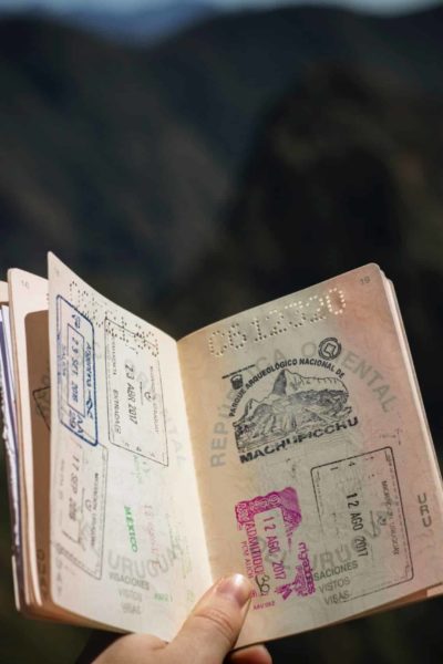 Passport being held open with a mountainous background